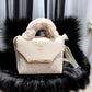 White luxury quilted handbag with soft faux fur handle and spacious interior for women.