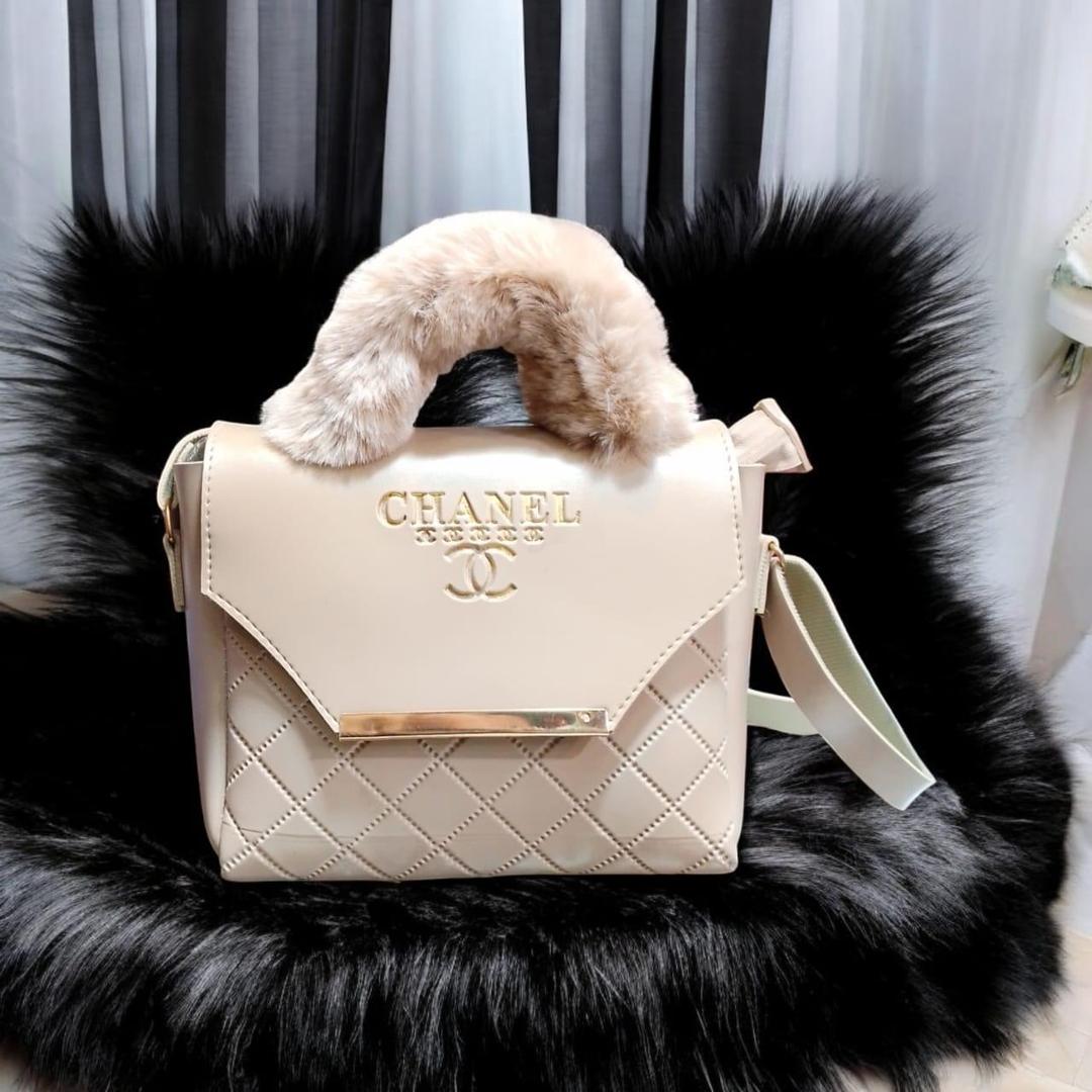 White luxury quilted handbag with soft faux fur handle and spacious interior for women.