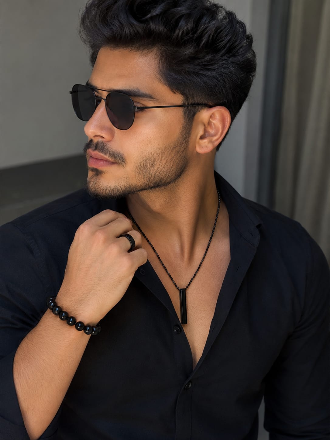Man wearing black pendant necklace from men's jewelry set