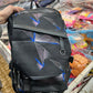 Black geometric backpack showing spacious interior capacity and practical compartment design