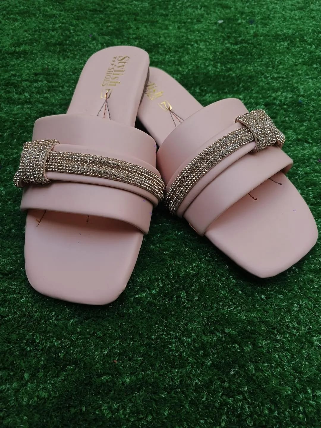 Pink women's sandals back view with stylish strap and flat sole