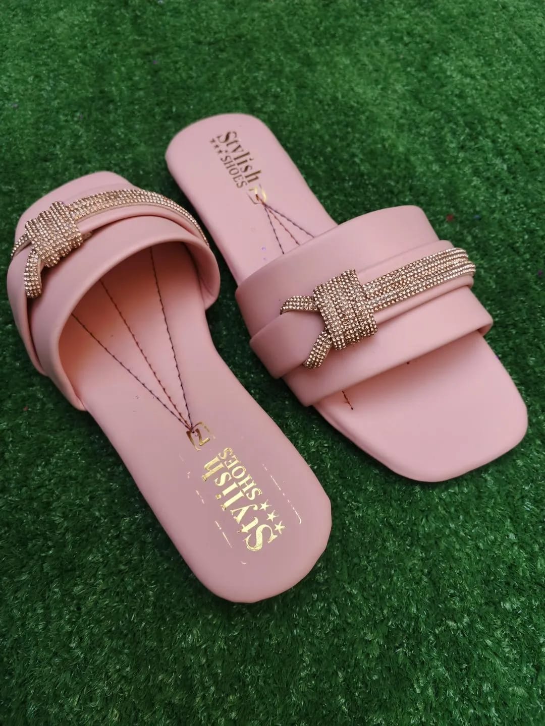 Pink women's flat sandals detailed view showing straps and sole design