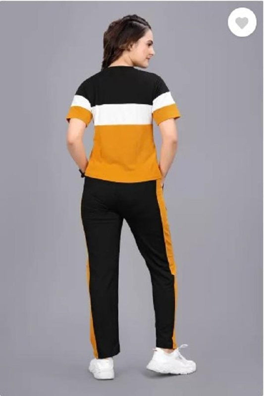 Back view of women's black orange tracksuit